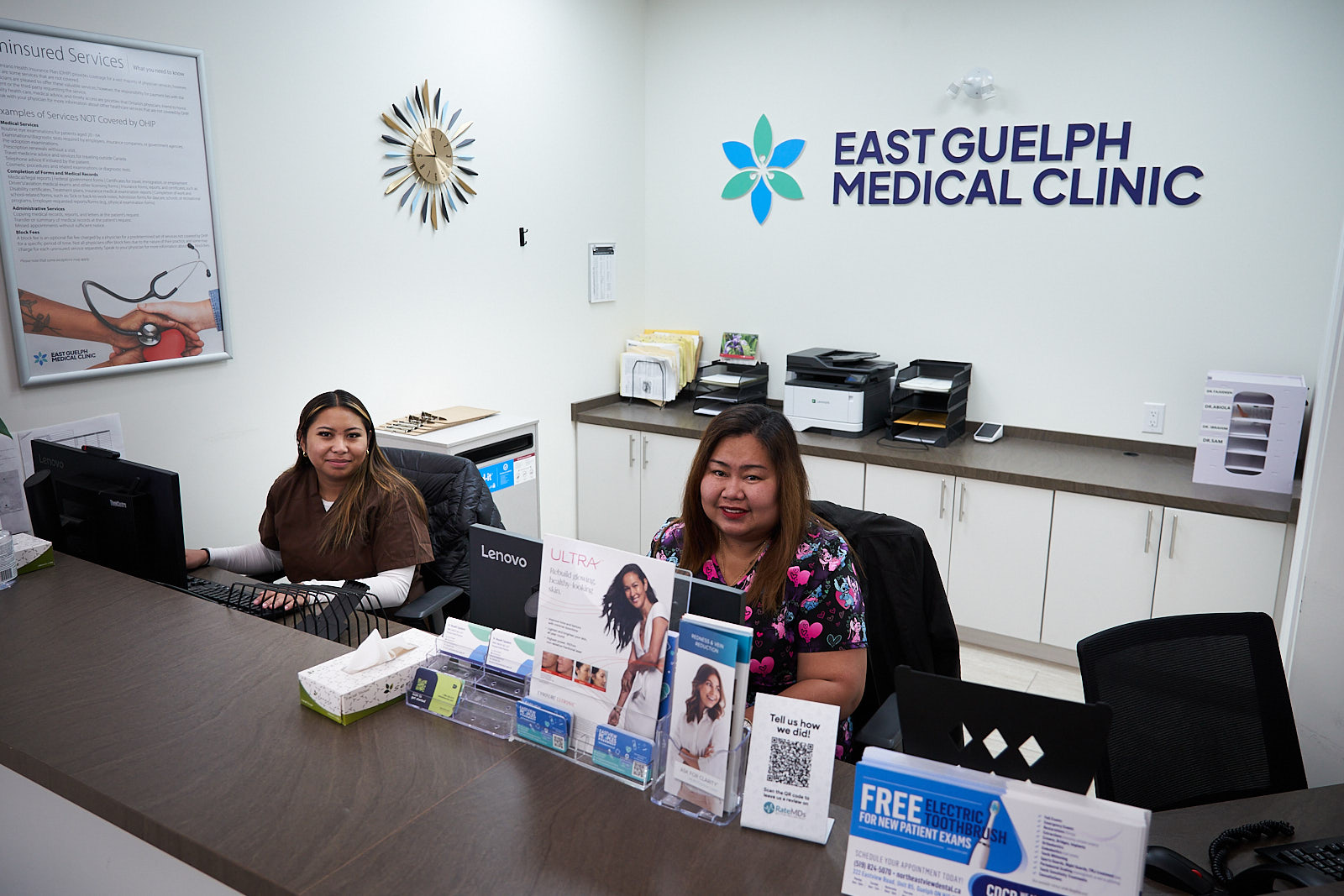 Front desk staff welcoming patients at the reception counter